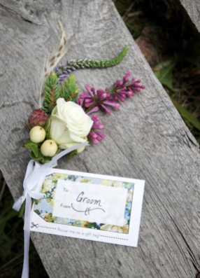 Alaska Weddings: Emily & Dan: bountonnières of spray roses, hypericum, foraged hemlock, lilac, veronica and feathers | Flowers by Natasha of Alaskaknitnat.com