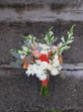 A creamsicle wedding | bridal bouquet made with peach roses, football mums, snapdragon, spray roses, lisianthus, limonium, hypericum and seeded eucalyptus. Designed by Natasha Price of Alaskaknitnat.com