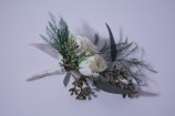 Boutonniere made with white spray rose, seeded eucalyptus and tree fern | designed by Natasha Price of alaskaknitnat.com